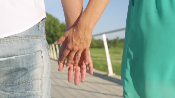 CLOSE UP: Newly engaged couple holds hands while on a romantic stroll in park. - Footage, Video