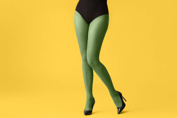 Beautiful young woman in tights on color background - Photo, Image