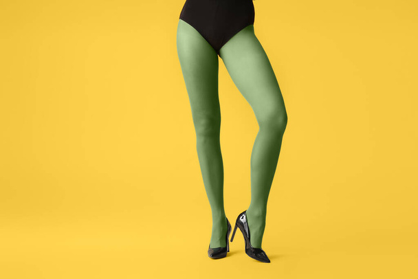 Beautiful young woman in tights on color background - Photo, image