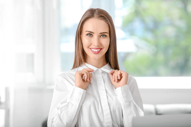 Beautiful businesswoman wearing modern shirt in office - Fotografie, Obrázek