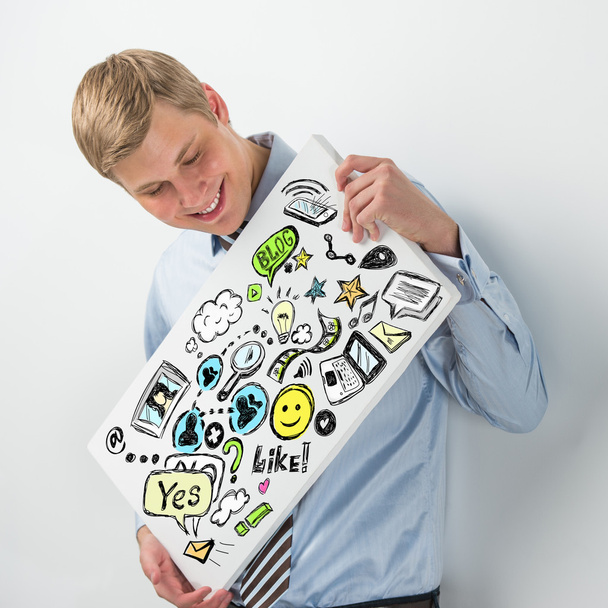 Business man holding a sign with online services symbols - Foto, Imagem