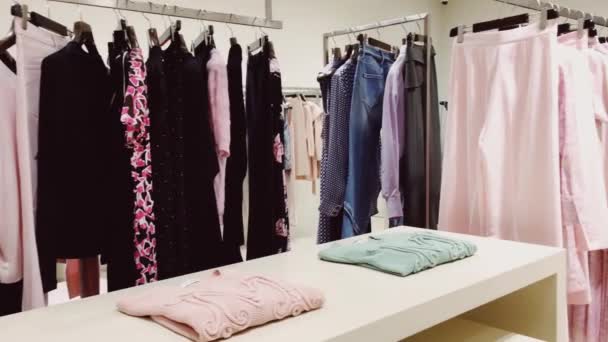 Stijlvolle kleding in boetiekwinkel, modern winkelinterieur, luxe winkel- en modecollectie - Video