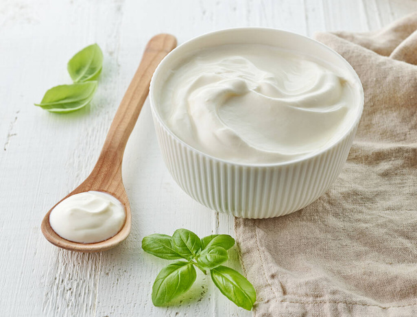 bowl of sour cream on white wooden table - Foto, immagini