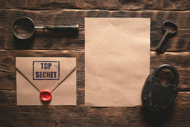 Top secret document paper page template on a wooden table of secret service agent flat lay background. - 写真・画像