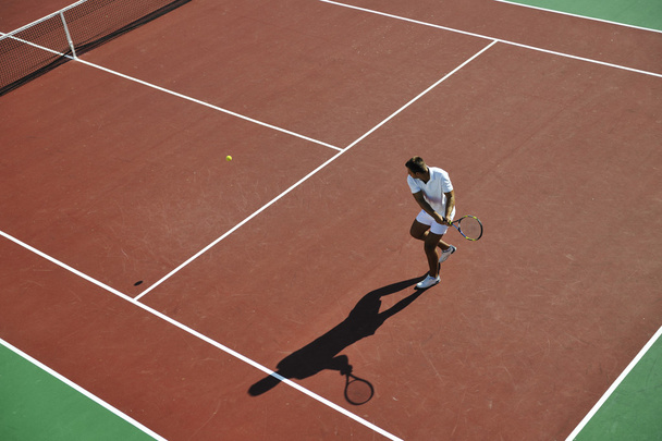 Young man play tennis outdoor - Fotó, kép