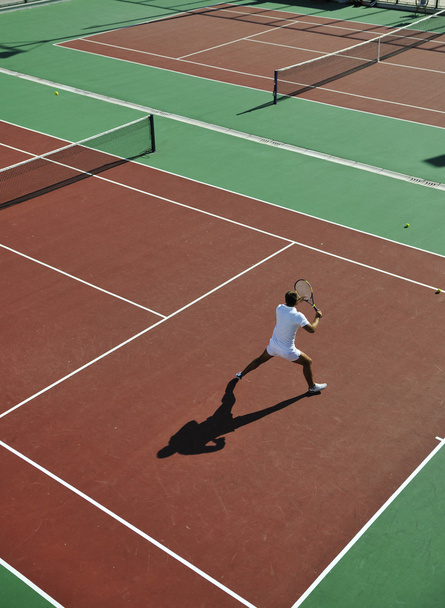 Young man play tennis outdoor - Fotó, kép