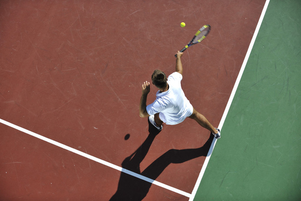 Young man play tennis outdoor - Фото, изображение