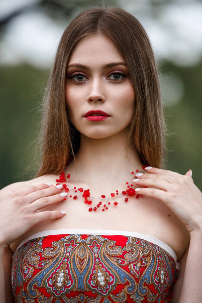 girl in a red dress in nature - Фото, зображення