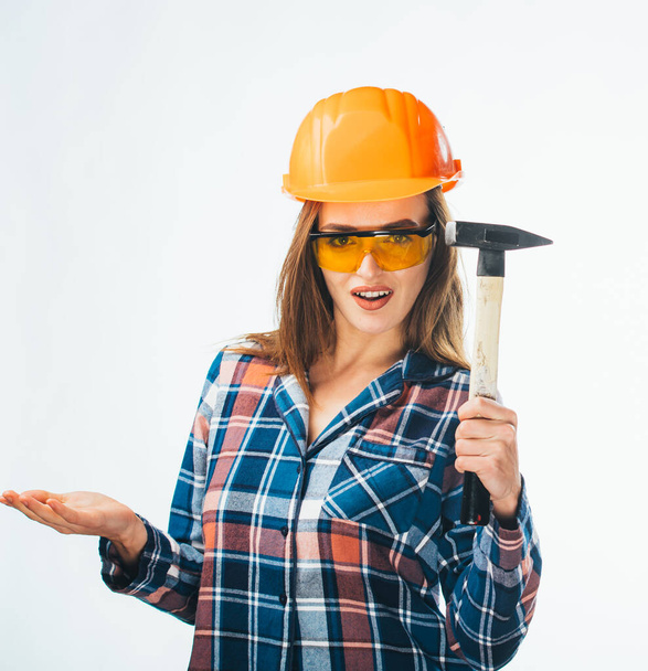 Young happy attractive girl in building orange helmet and glasses with hammer. Full isolated studio picture from emotional craftswoman. - Foto, immagini