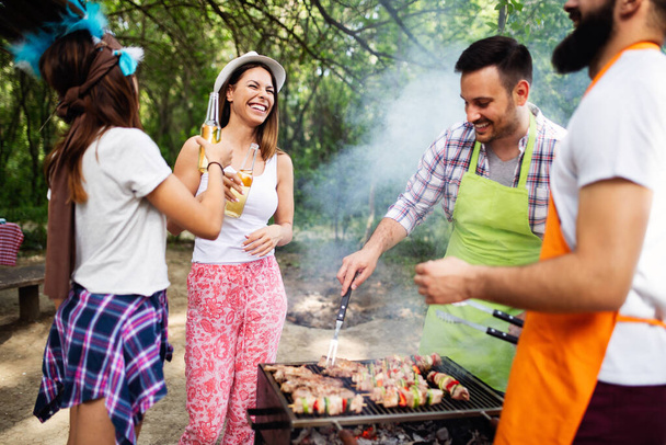 Group of friends having outdoor barbecue party and fun together - Foto, Imagem