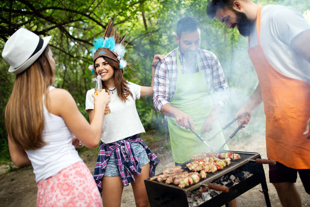 Group of young friends having barbecue party, outdoors - Foto, imagen