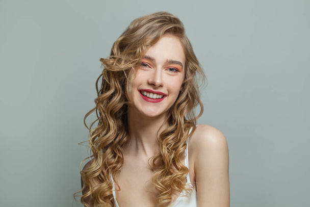 Kaunis nainen kiharat hiukset ja terve kirkas iho valkoisella taustalla - Valokuva, kuva