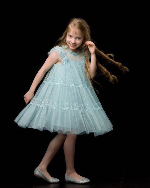 A cheerful little girl is dancing.The concept of a school of dan - Photo, Image