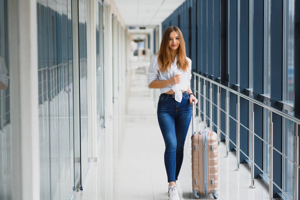 Pretty young female passenger at the airport (shallow DOF; color toned image) - Foto, Bild