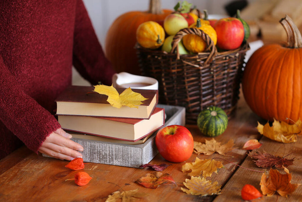 books, cup of tea and pumpkins on table  - Photo, Image