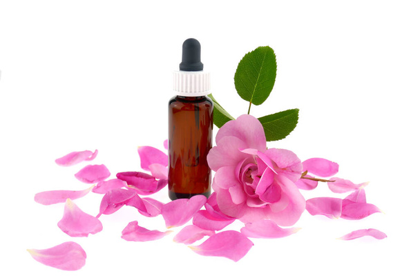 Óleo essencial de rosa.Garrafa de óleo e rosa flor
 - Foto, Imagem