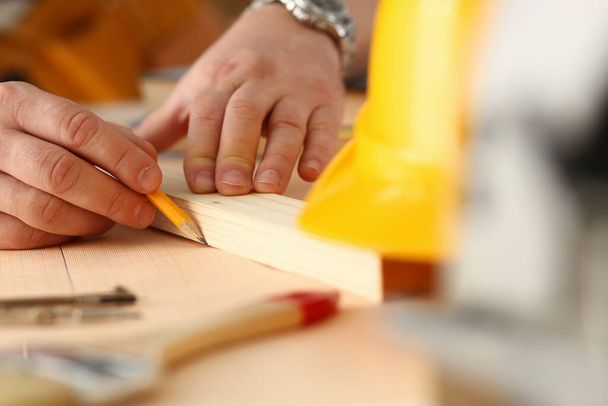 Male builder hands drawing line on sheet of paper - Φωτογραφία, εικόνα