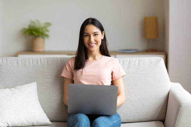 Cheerful Girl Sitting With Laptop On Couch Working From Home - Photo, Image
