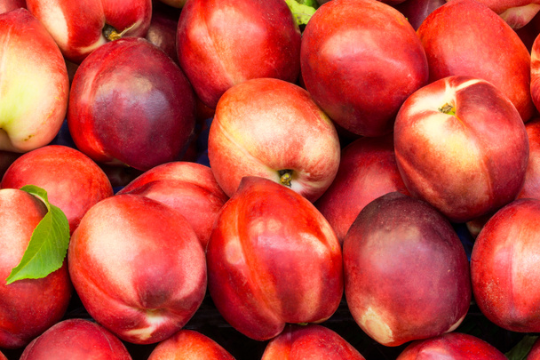 red nectarine on a market counter close up - Foto, imagen