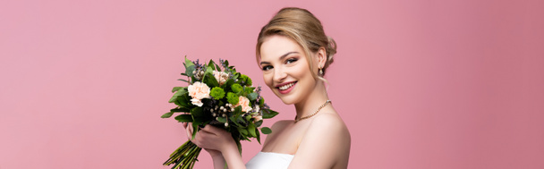 orientamento panoramico della sposa che tiene fiori di nozze isolati su rosa  - Foto, immagini