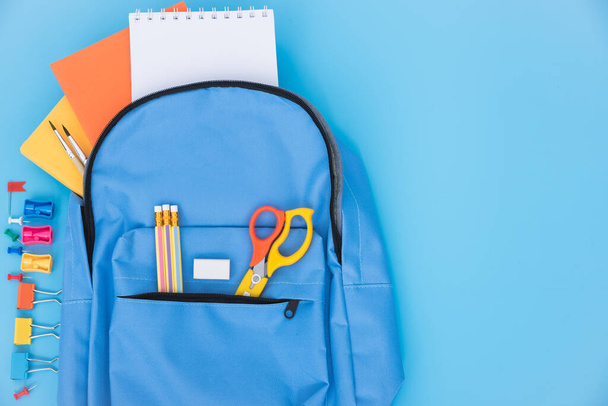 Top view flat lay of blue school bag backpack and accessories tools for children education on blue background, Back to school concept and have copy space for use - Fotografie, Obrázek