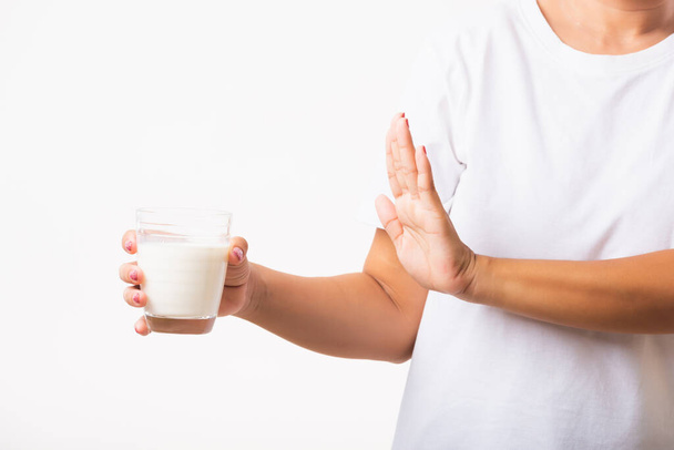 閉鎖女性は彼女が悪い胃の痛みは乳糖不寛容不健康な問題を持っているガラスミルクを保持している手を使用してサインを停止するために手を上げ乳製品と,スタジオショット白の背景に隔離 - 写真・画像