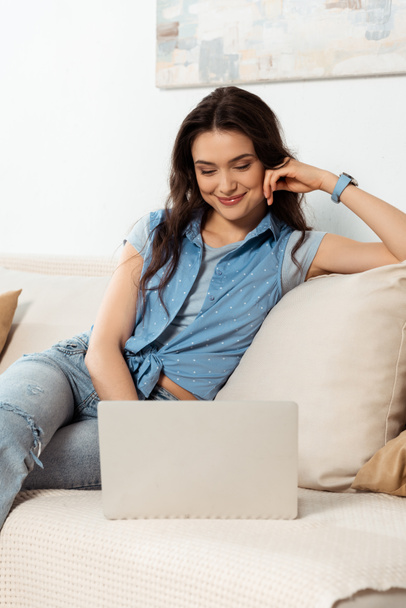 Beautiful smiling freelancer using laptop at home  - Foto, imagen