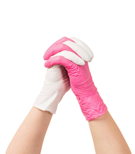 Trabalhador de saúde mãos juntando e vestindo luvas brancas e rosa
 - Foto, Imagem