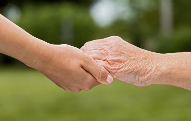 The helping hands for elderly home care outdoors - Photo, Image
