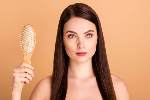 Close up photo of serious dreamy girl hold hairbrush try new natural shampoo want prepare for party prom to become real wellness beauty isolated over beige color background - Valokuva, kuva