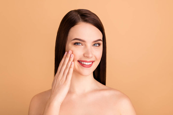 Close up photo of positive girl look in mirror like her new skincare beauty salon treatment lifting therapy to make her skin pure tone complexion isolated over beige color background - Photo, image