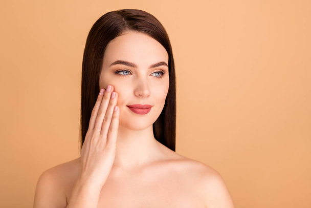 Close up photo of dreamy girl touch her hand try her new collagen skincare treatment to make her skin silky isolated over beige color background - Фото, зображення