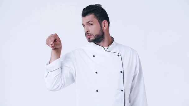 chef in uniform sprinkling salt isolated on white - Video, Çekim