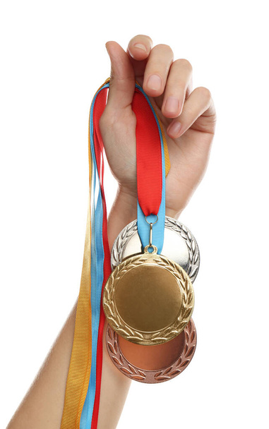 Woman holding medals on white background, closeup. Space for design - Foto, Imagen
