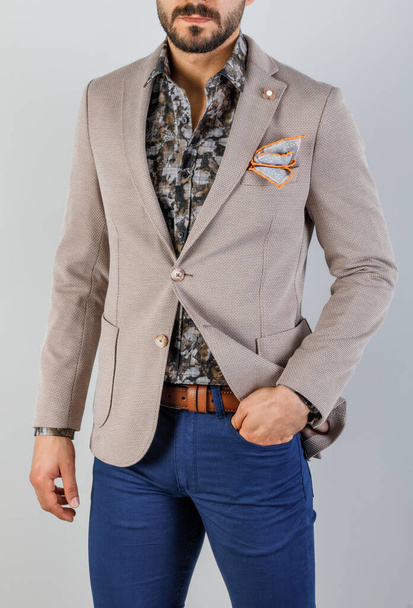 the handsome young man beige jacket on a white background - Foto, Imagen