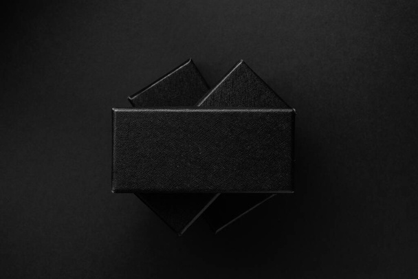 Black rectangular boxes on a black background. Place for text. - Photo, Image