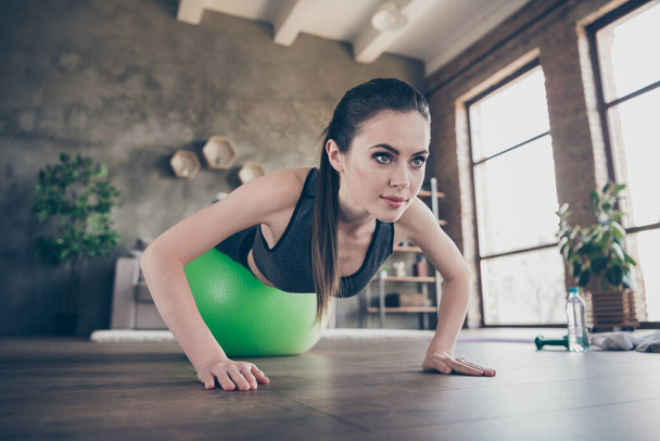 Closeup photo of beautiful lady quarantine hobby training home dynamic practicing legs on fit ball plank push-ups press exercise biceps hands muscles stand on arms living room indoors - Photo, Image