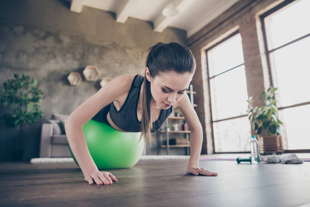 Closeup photo of beautiful lady quarantine hobby training home dynamic pilates stretching practicing legs on fit ball plank push-ups exercise biceps muscles stand on arms living room indoors - Foto, Imagem