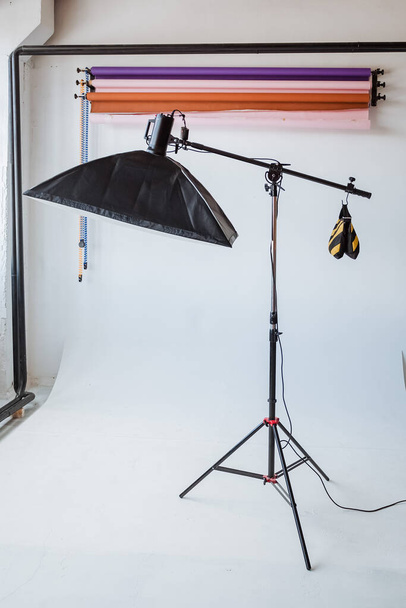 photo Studio interior, white cyclorama, colored backgrounds, lighting device on a tripod - Photo, image