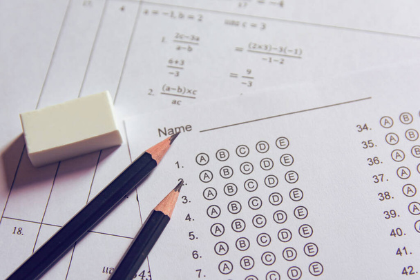 Pencil and eraser on answer sheets or Standardized test form with answers bubbled. multiple choice answer sheet - Photo, Image