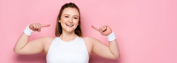 panoramic crop of cheerful overweight girl pointing with fingers at herself on pink - Photo, Image