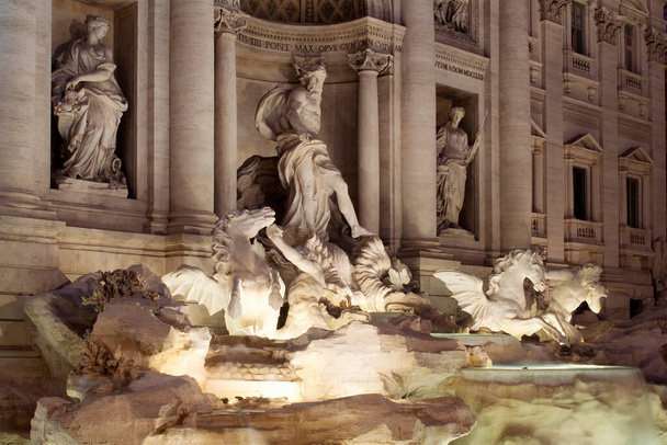 View of Fontana Di Trevi at night in Rome. Aqueduct-fed rococo fountain, designed by Nicola Salvi & completed in 1762, with sculpted figures. - Fotoğraf, Görsel