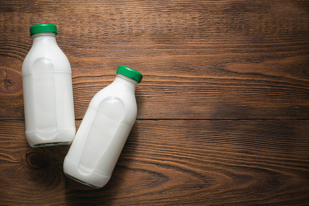 Bottle of milk on a wooden table flat lay background. - Photo, Image