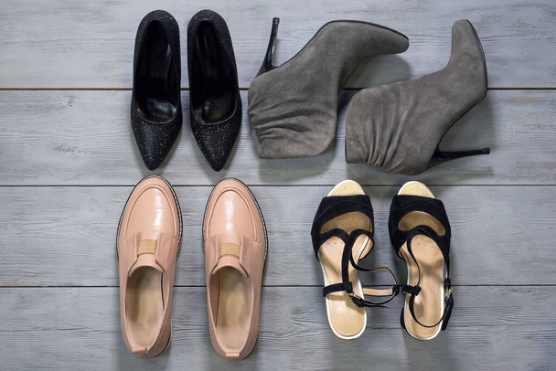 Various footwear on a wooden floor background. - Photo, Image