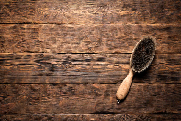 Old brush over brown wooden background with copy space. - Фото, зображення