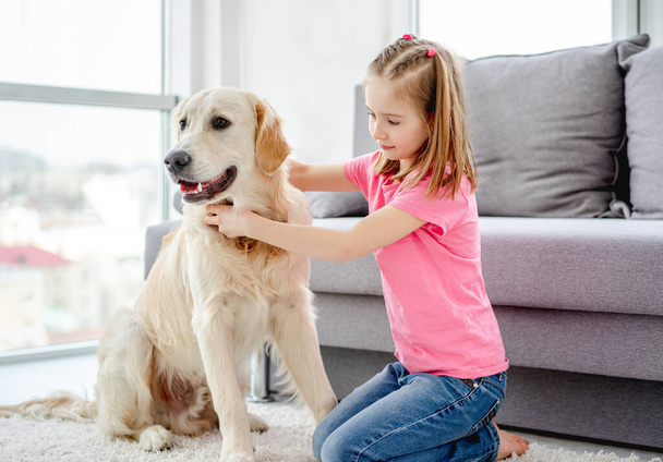 Pretty little girl with golden retriever - Photo, Image