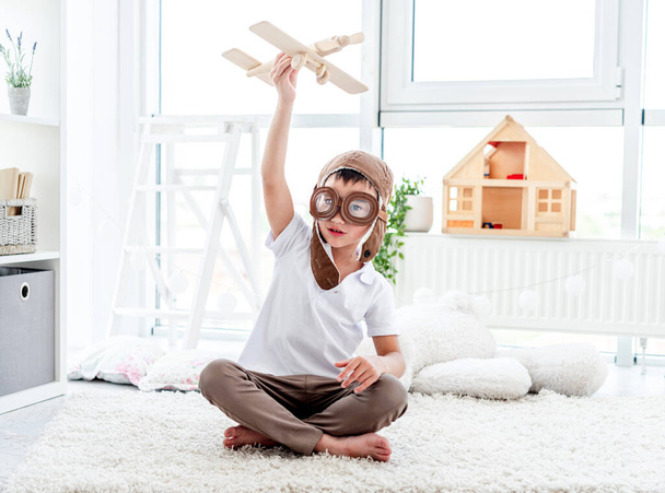 Happy little boy playing with plane - Foto, imagen