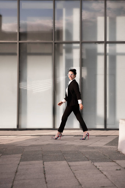 Powerful portrait of a small business owner standing in front of her modern workplace. - 写真・画像