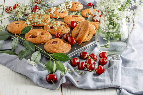 Newly baked  cherry muffin on a muffin tray - Fotografie, Obrázek