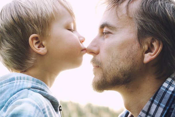 Cute toddler child boy kisses his father on nose. Tenderness, love, dad and son relationship, fathers day concept. Happy family moments.   - Fotoğraf, Görsel